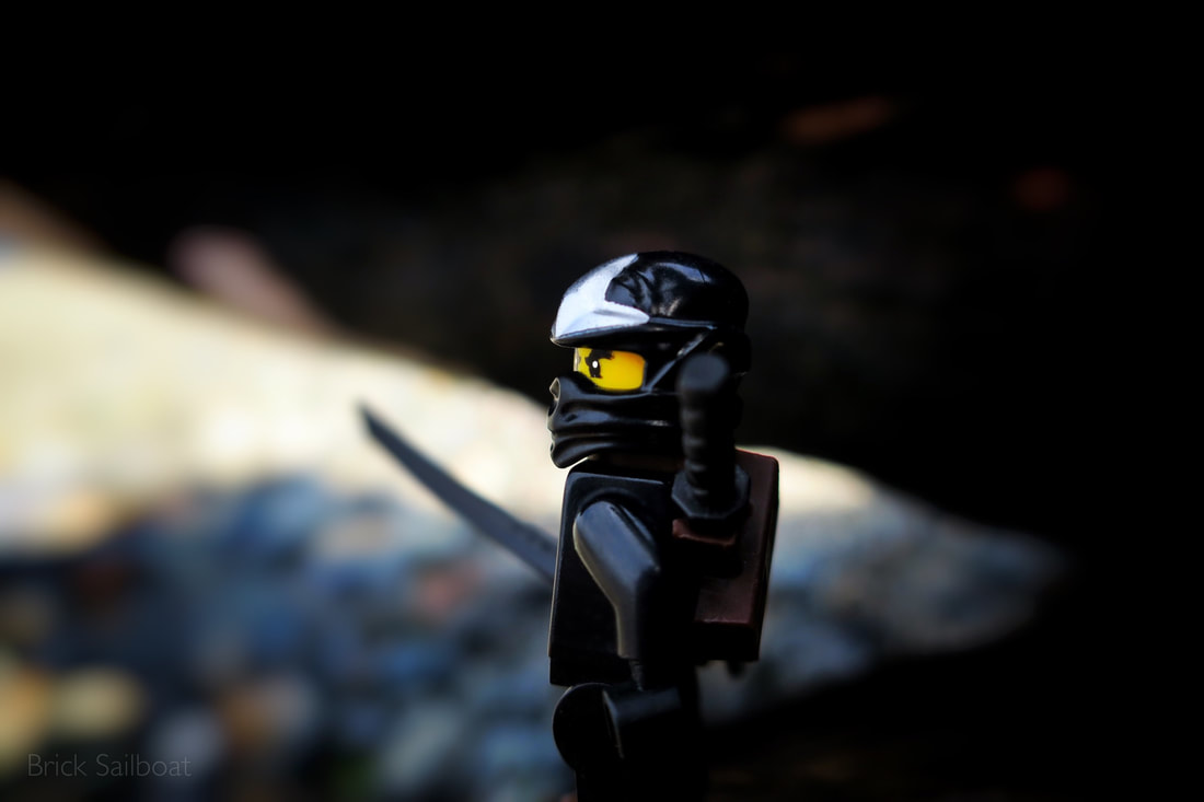 Black Ninjago ninja on guard with his samarai sword