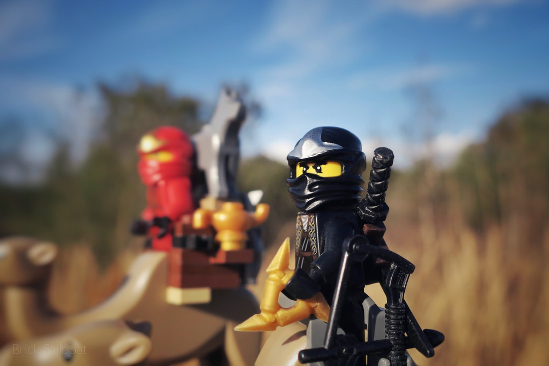 The black and red ninja travel with statue Rover near the forest.