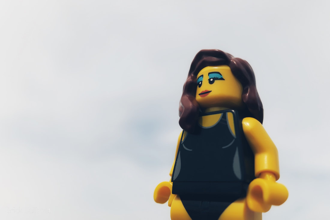 A LEGO minifigure chillin' on a cloudy day at the beach